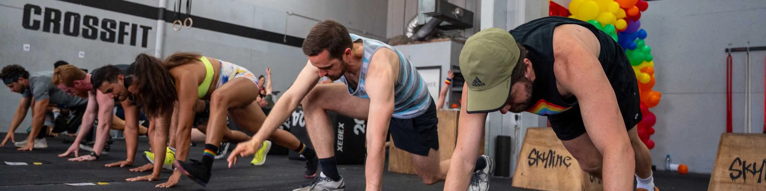 A line of athletes training in a CrossFit gym.
