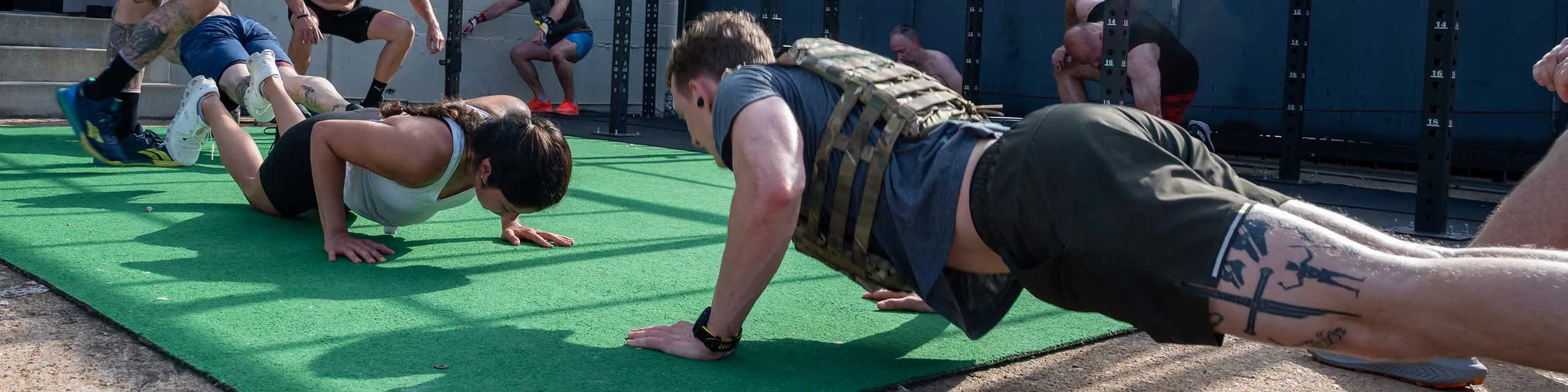 Gym members doing push-ups during a class.