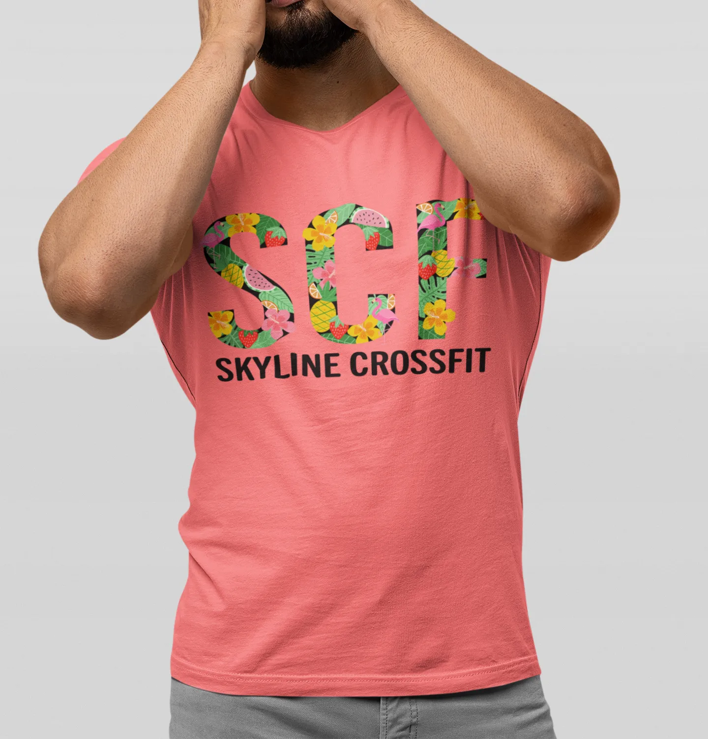 A Skyline CrossFit tee with a floral SCF design on a coral shirt.